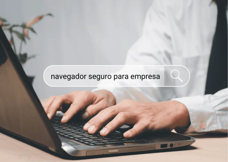 Em foco, está uma laptop sobre uma mesa com um homem branco com ambas as mãos sobre o teclado e veste camisa branca de mangas compridas; sobre a imagem, está um campo de digitação de busca, no qual está escrito "navegador seguro para empresa" e, logo à direita, uma lupa indicando ser um sistema de buscas; exemplificando qual o navegador mais seguro para empresa.